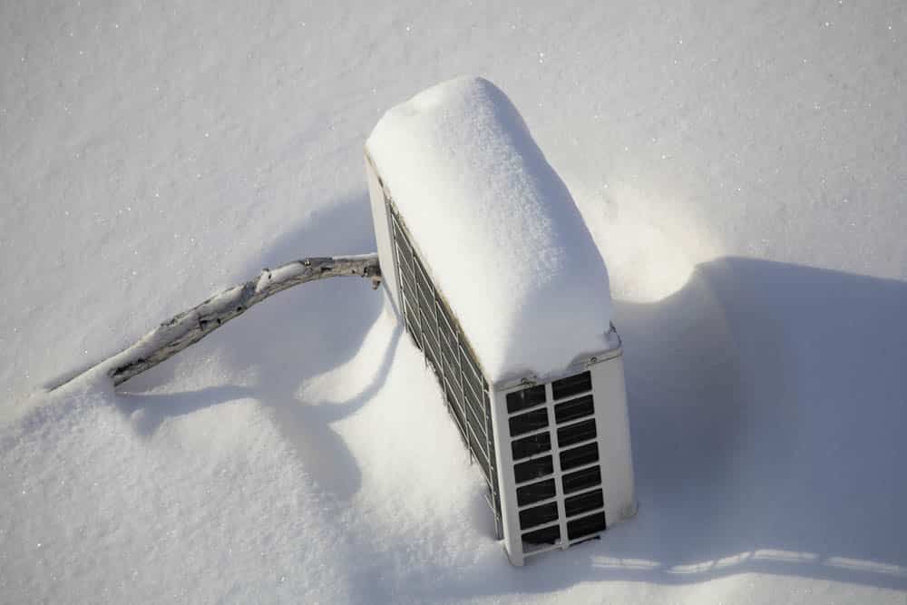 Air conditioner covered with snow on root top