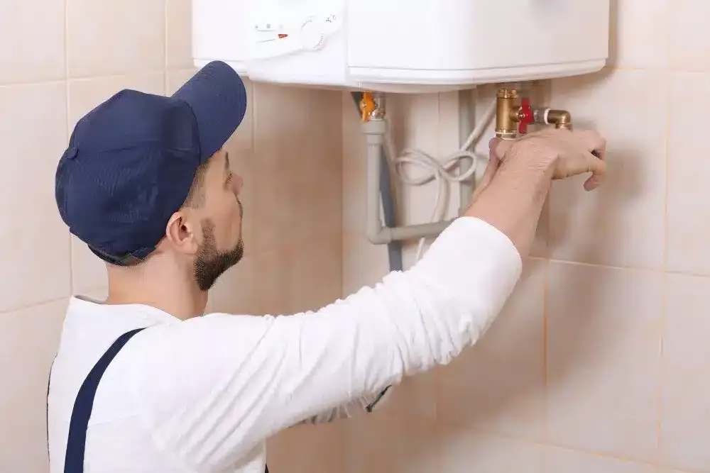 plumber-installing-water-heater-i n thebathroom