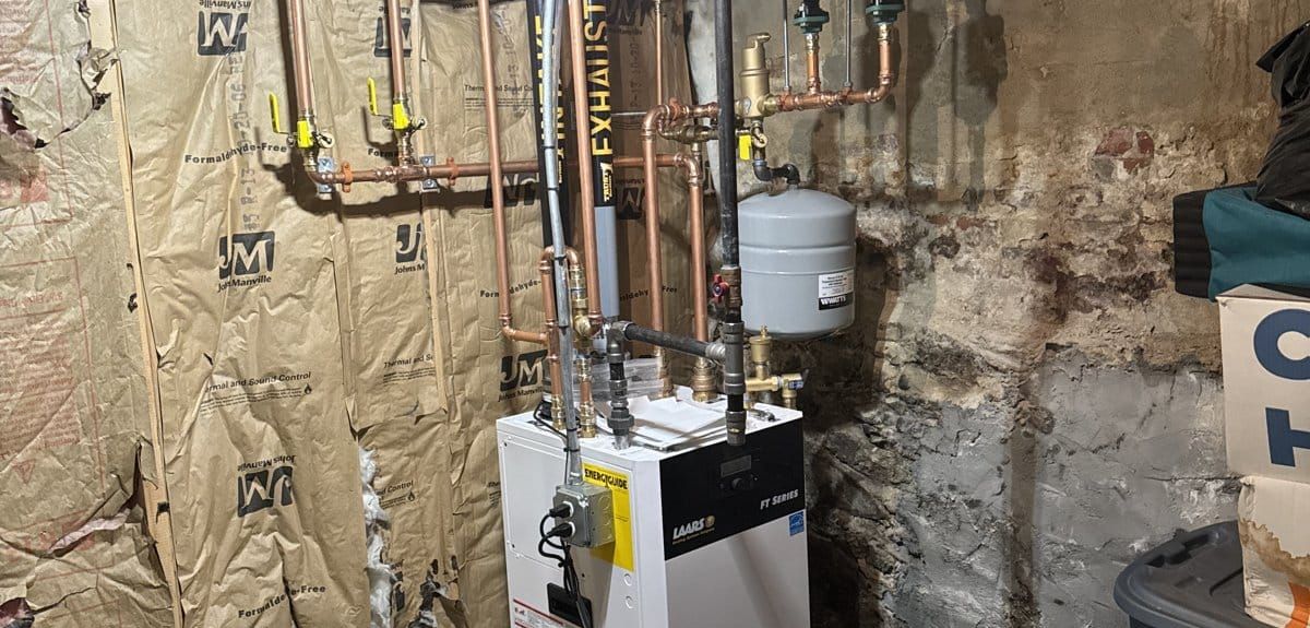 New Laars FT Series combi boiler with copper near-boiler piping installed by Trust 1 in a basement