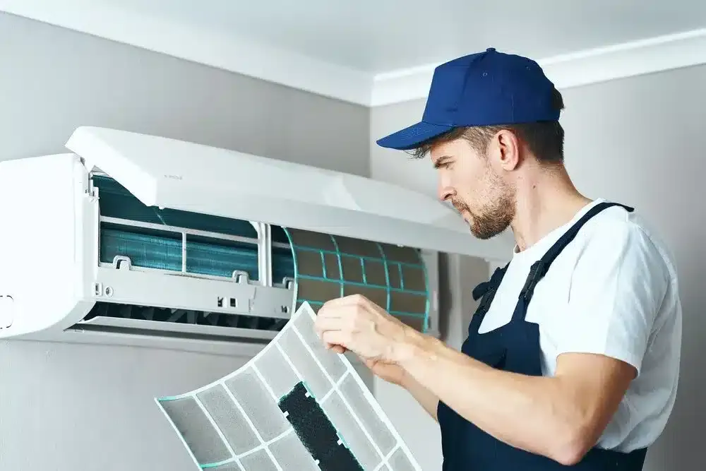 worker repairing and -cleaning-air-conditioner-at home
