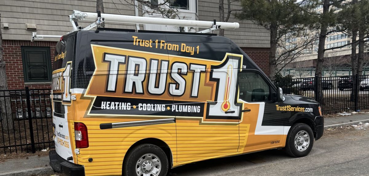 Trust 1 Heating, Cooling & Plumbing service van parked outside a home in Quincy, MA
