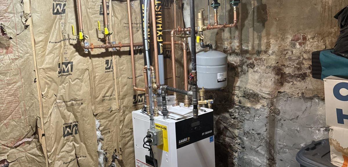 Floor-mount Laars combi boiler with copper near-boiler piping installed by Trust 1 in a basement