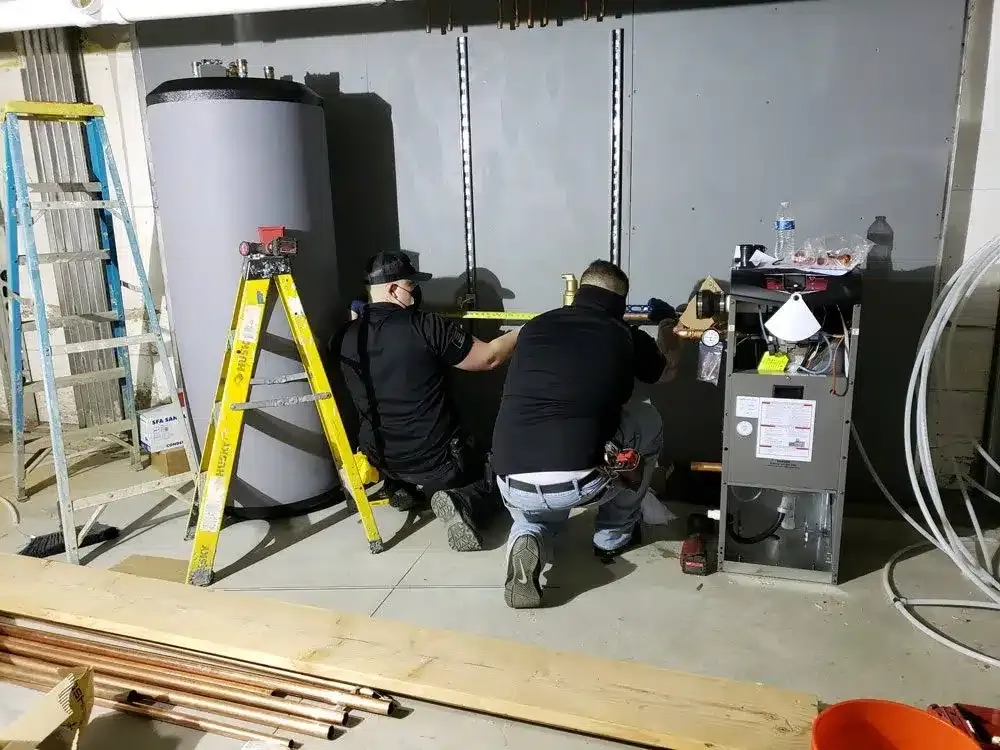 technicians work on the repairing the water heater