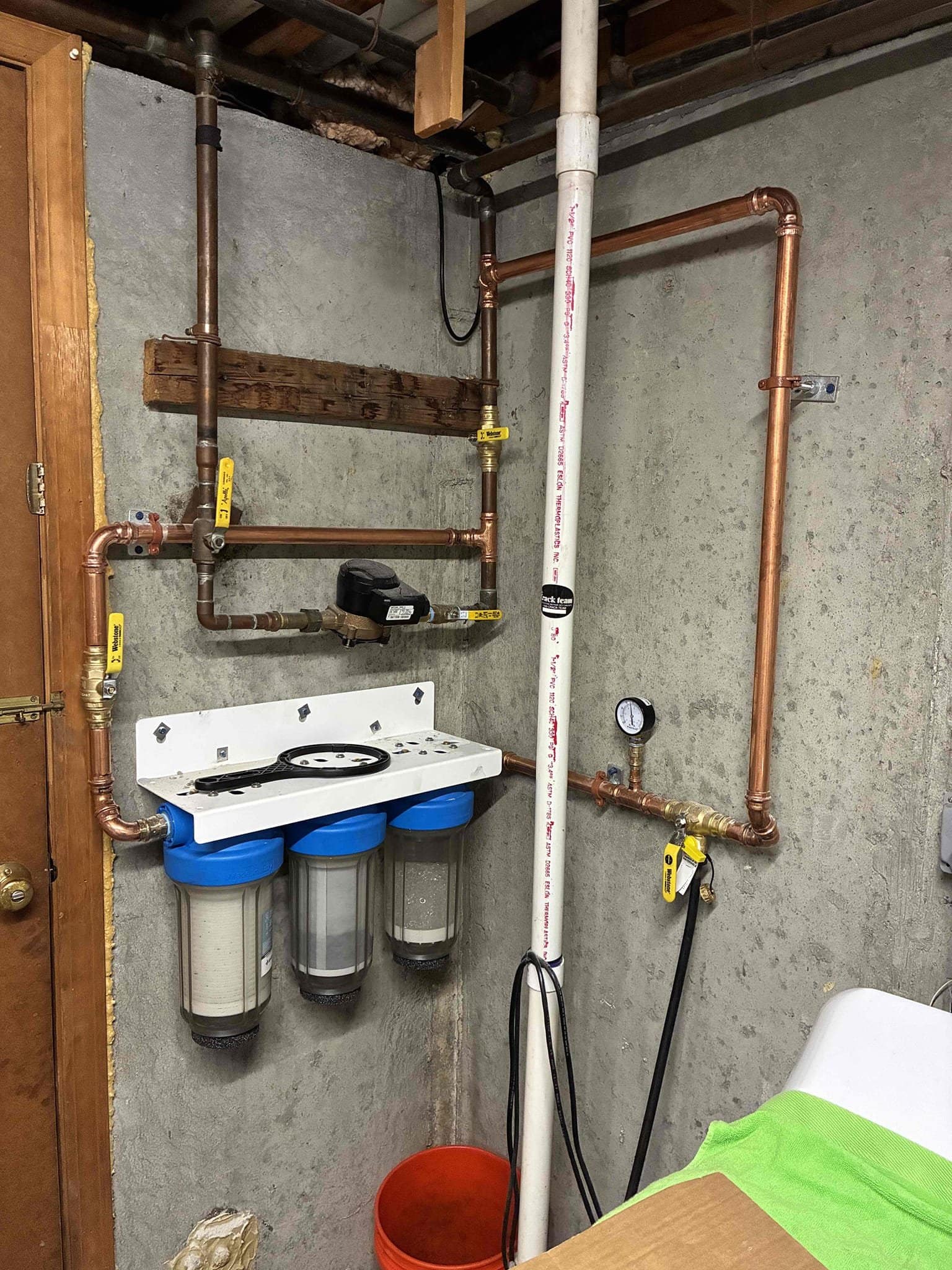 Standard 3-stage whole-home water filtration system installed by Trust 1 in a basement